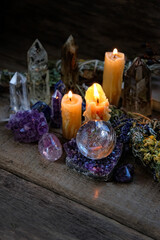 Candles, floral cleansing bundles, magic things, gemstones minerals on dark rustic background. healing minerals for Magic Rock Ritual, Witchcraft, spiritual practice. Esoteric, halloween concept
