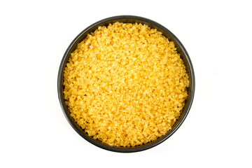 Sugar from sugarcane in black bowl isolated on white background, Top view.