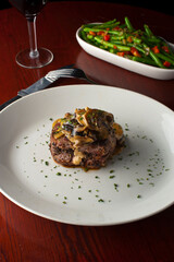 Steak dinner w/ vegetables. Traditional classical American or French Bistro main course, steak and mashed potatoes. Steak, cooked medium rare served with garlic mashed potatoes and kale salad.  