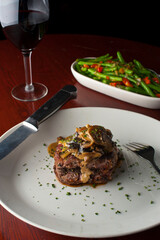 Steak dinner w/ vegetables. Traditional classical American or French Bistro main course, steak and mashed potatoes. Steak, cooked medium rare served with garlic mashed potatoes and kale salad.  