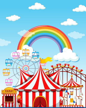 Amusement park scene at daytime with rainbow in the sky