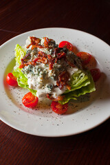 Wedge Salad. Iceberg Lettuce, blue cheese dress and shredded carrots. Classic American steakhouse or restaurant favorite. 