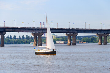 White modern sailboat sailing on the Dnieper river in Kiev, Ukraine