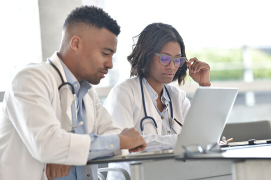 Young doctors working on laptop at the hospital