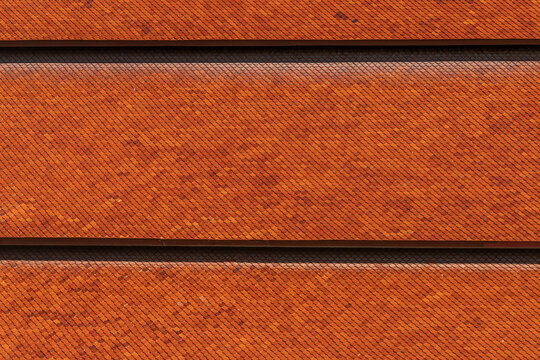 Abstract background Buddhist temple roof in Thailand, pattern small roof tiles, brown color, natural daylight.