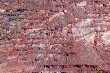 Close-up of red mining levels at iron ore quarry. Open-cast mine, open pit. Background, texture
