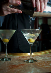 Old Fashioned Cocktail. Traditional American craft cocktails made by artisanal bartenders or mixologists in speakeasy & upscale bars or dive bar taverns. Cocktails served in chilled cocktail glass.