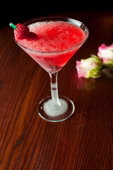 Cosmopolitan Cocktail. Action shot. Alcoholic Drinks made with gin, vodka, rum or whiskey mixed with soda water, fruit juices and garnishes with limes and cherries. Classic American bar drinks.