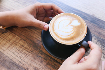 high angle view of women holding coffee cup.
