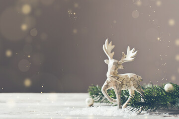 Christmas card conception. Christmas toy deer decoration with christmas tree branch and snow