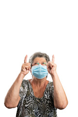 Old female model pointing index at copyspace wearing medical mask