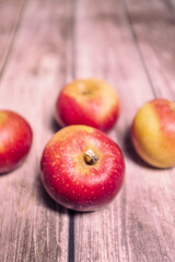 Red tasty fresh apples on a striped wooden surface