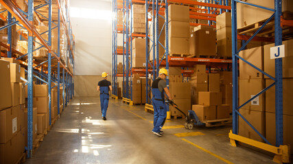 Retail Delivery Warehouse full of Shelves with Goods in Cardboard Boxes, Workers Scan and Sort Packages, Move Inventory with Pallet Trucks and Forklifts. Product Distribution Logistics Center. © Gorodenkoff