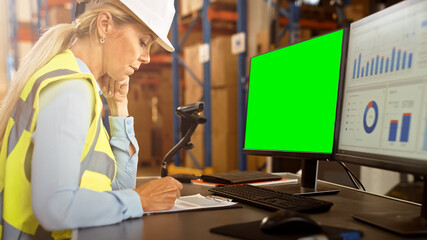 Professional Female Worker Wearing Hard Hat Uses Computer with Green Chroma Screen and Inventory...