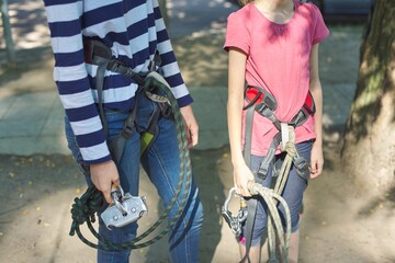 Children prepare for a bungee jump, put on safety belts