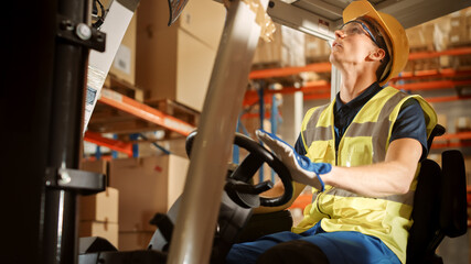 Retail Warehouse full of Shelves with Goods: Electric Forklift Truck Operator Lifts Pallet with Cardboard Boxes On a Shelf. People Working, Scanning Products, Using Trucks in Distribution Center © Gorodenkoff