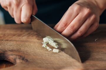 Close up shot of chef chopping garlic