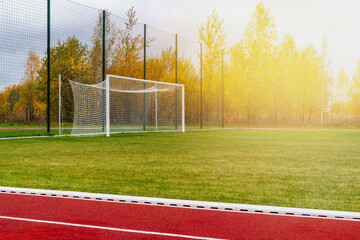 Outdoor athletics treadmill running track with behind football gate