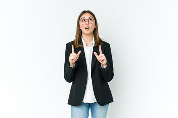 Young caucasian business woman pointing upside with opened mouth.