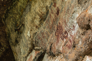 Prehistoric paintings in the cave at Phu Sra dok Bua National  park Mukdahan province, Thailand.