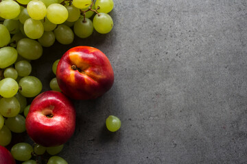 Colorful fruit frame on dark background. Summer fruits top view photo with copy space. 
