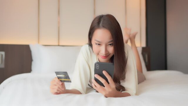 Rich asian woman mindlessly shopping online