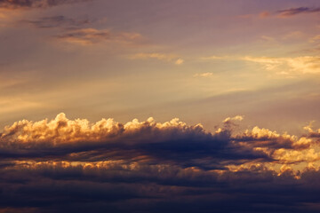 Red and pink clouds in the sunset sky. Natural background with space to copy