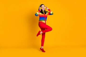 Fototapeta na wymiar Full body photo of young happy smile woman listen music melody radio hands touch earphones isolated over yellow color background
