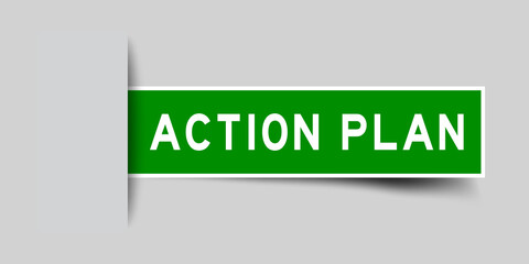 Inserted green color sticker label with word action plan on gray background