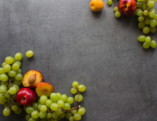 Colorful fruit frame on dark background. Summer fruits top view photo with copy space. 