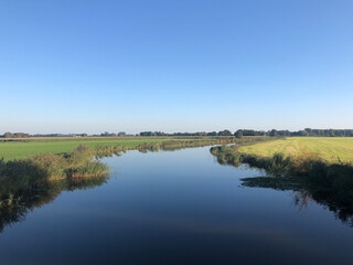 Quiet canal around tersoal in Friesland