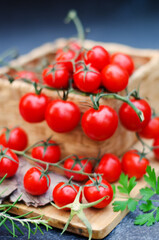 Food photography of fresh cherry tomatoes with herbs on a wooden table close up.  Top view. Flat lay. 