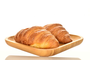 Fragrant homemade croissant, close-up, on a white background.
