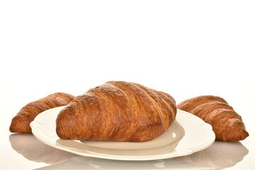 Fragrant homemade croissant, close-up, on a white background.