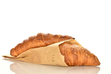 Fragrant homemade croissant, close-up, on a white background.