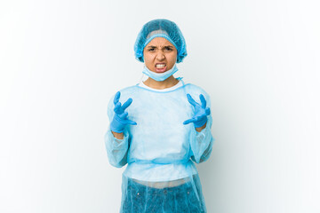 Young surgeon latin woman isolated on white background upset screaming with tense hands.