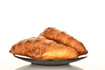 Fragrant homemade croissant, close-up, on a white background.