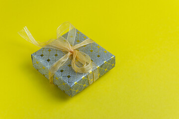 large gift box with yellow ribbon. close-up
