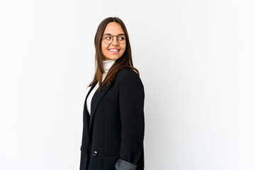 Young mixed race business woman isolated on white background looks aside smiling, cheerful and pleasant.