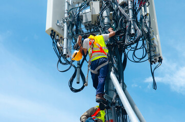 Engineer or Technician wear safety equipment climb high telecom tower for maintenance work,working high risk, Installation and Preventive maintenance on telecommunication network 