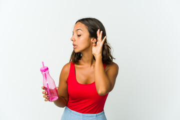 Young latin woman holding a milkshake isolated on white background