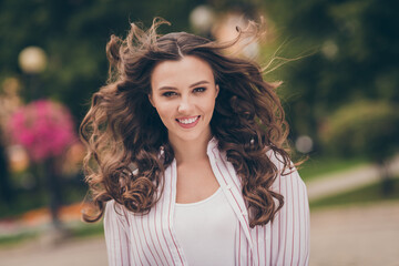Fototapeta premium Photo portrait photo of confident pretty girl throwing hair on windy weather walking on the street