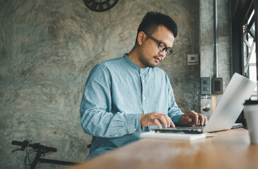 smart Asian man working with computer laptop. concept work form home, stay at home. freelance life style.