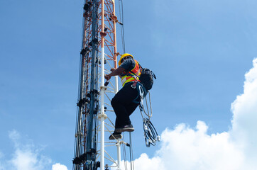 Engineer or Technician wear safety equipment climb high telecom tower for maintenance work,working high risk, Installation and Preventive maintenance on telecommunication network 