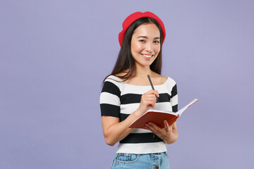 Smiling pretty young brunette asian student woman 20s wearing striped t-shirt red beret standing...
