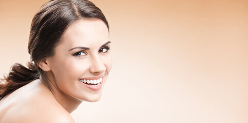 Young happy smiling woman, over color background, with blank copy space area for advertising slogan...