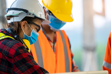 Construction workers wear protective face masks to prevent the spread of Covid 19 by wearing a face mask,Corona virus disease.