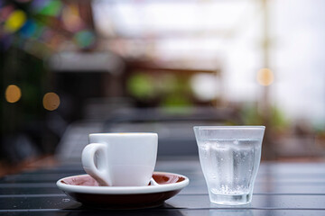 Cafes and restaurants. A mug of invigorating, black coffee on dark gray background. Place for an inscription. The concept of hot drinks.