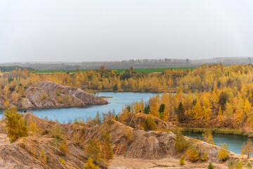 Aerial autumn view of picturesque hills and blue lakes in Konduki, Tula region, Russia.