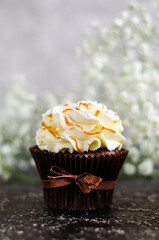 Homemade cupcakes with caramel syrup and cream cheese